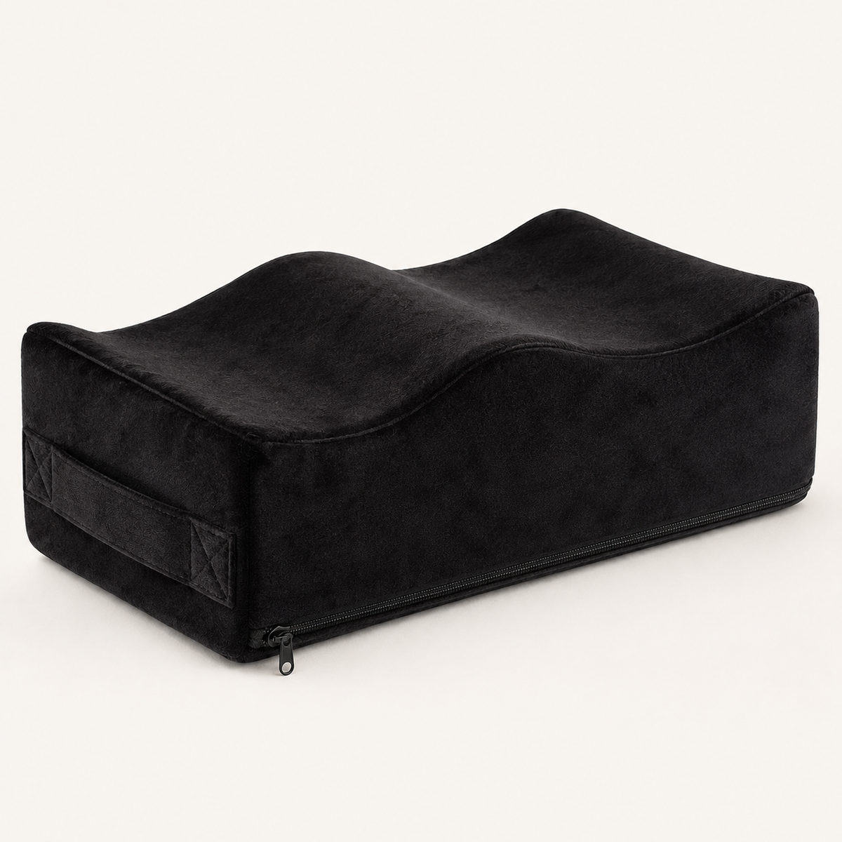 Ostinea Cushion in black velvet, shown at a three-quarter angle with raised contours and a recessed center.
